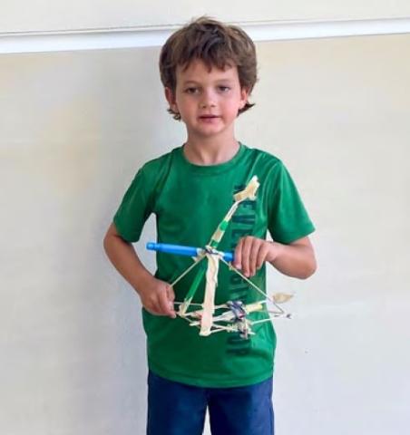 Child showing machine built during class