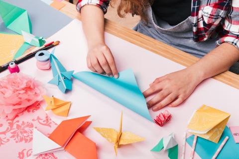 woman hands folding paper 